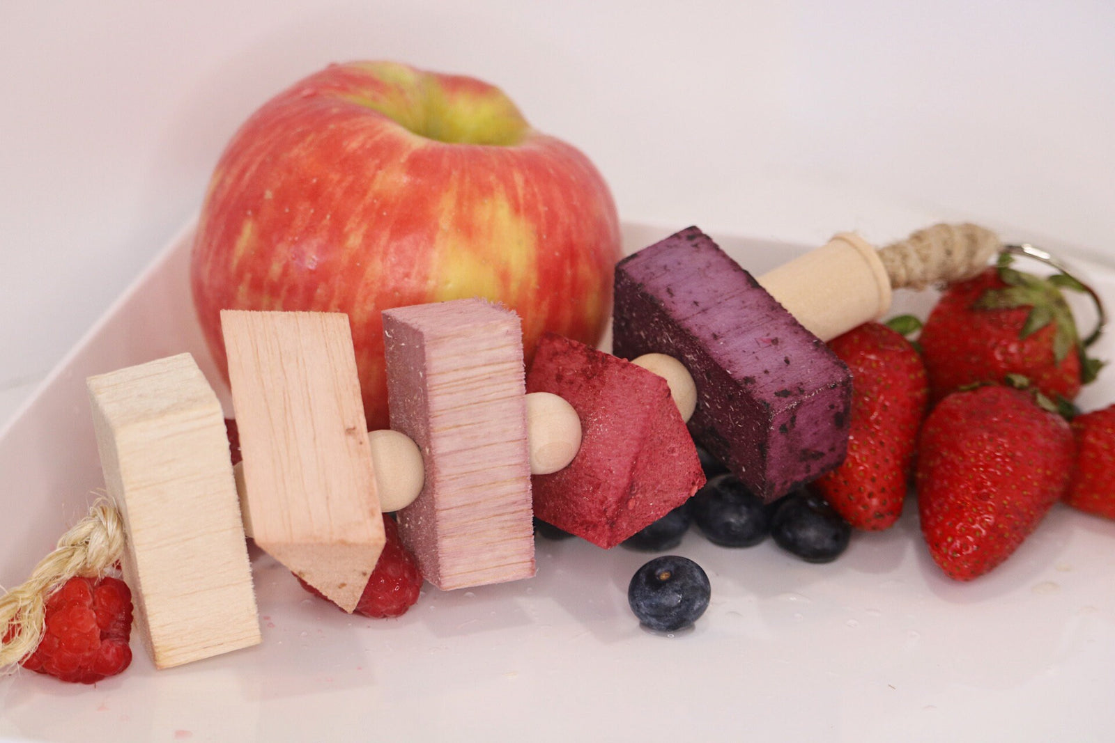 Fun4Bunnies flavored balsa chew hanging toys for small pets flavored with blueberry, raspberry, grape, strawberry and apple